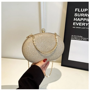 Detail of champagne gold glitter evening bag with crystal clasp and ring handle