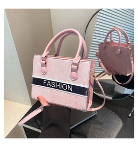 Détail du sac cabas rose à motif marbre avec bandoulière réglable et texte fashion