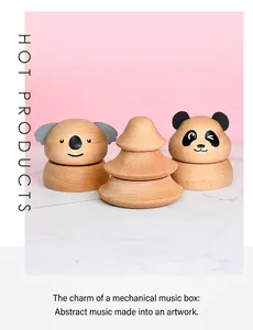 Macro detail of handmade wooden music boxes featuring panda and koala animal designs