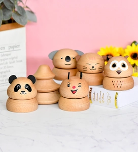 Charming collection of wooden animal music boxes displayed on a modern marble tabletop