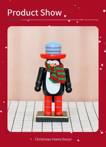 Detailed view of a 16cm wooden penguin nutcracker with festive scarf and hat decoration