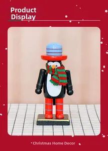 Detailed view of a 16cm wooden penguin nutcracker with festive scarf and hat decoration
