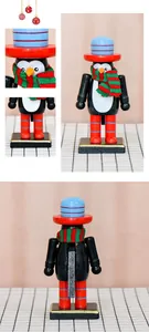 Detailed views of 16cm wooden penguin nutcracker with red hat and striped scarf