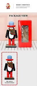 Detailed view of 16.5cm penguin nutcracker ornament with red top hat and gift box packaging