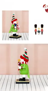 Detail of wooden snowman nutcracker in green with striped knit hat holding a gift box