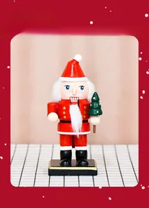 Close-up of a 16cm wooden Santa Claus nutcracker figurine with a mini green Christmas tree