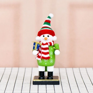 16cm wooden snowman nutcracker ornament with knitted hat and gift box on a stable base