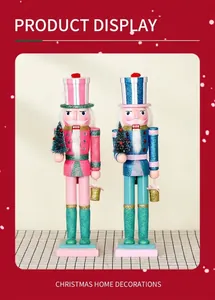 Detail showing two wooden glitter nutcracker soldiers with miniature Christmas trees