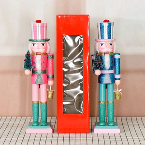 38cm wooden glitter nutcracker figures in pink and blue with a festive red gift box