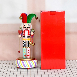 Nutcracker clown wooden music box with colorful base and festive red gift box package