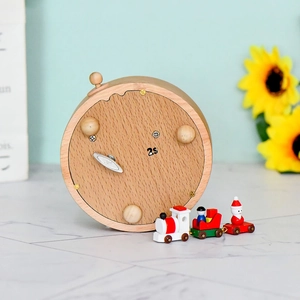 Mechanical wooden Christmas music box with miniature rotating train on light wood base