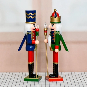 Pair of 38cm wooden nutcracker soldiers with scepter and spear on checkered surface
