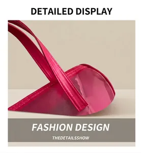 Detail view of pink mesh makeup bag featuring smooth leather handles and precision stitching