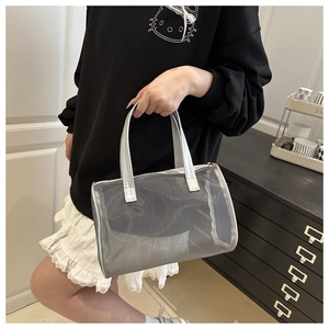 Detail of silver translucent mesh Boston bag with metallic faux leather handles