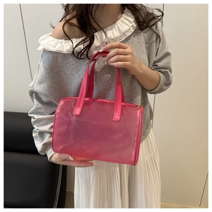 Detail of pink transparent mesh shoulder bag with matching synthetic leather handle and zipper