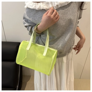 Detail of neon green mesh handbag showing the translucent micro-mesh texture and sturdy handle