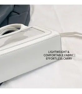 Detail shot of white faux leather and PVC stitching on a retro crossbody bag with strap