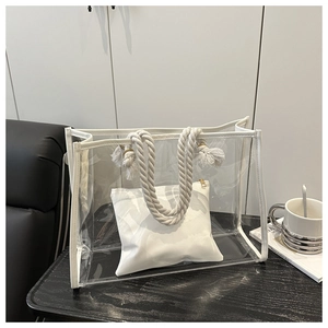 Detail of transparent PVC tote bag with white rope handles and inner privacy pouch