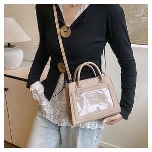 Lifestyle view of the beige PU leather crossbody bag with a clear PVC front window panel