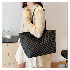 Detail view of a large tote bag with geometric pattern and sturdy shoulder straps