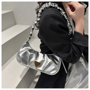 Metallic silver hobo bag with pleated shoulder strap and triangular metal logo detail