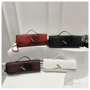 Detailed display of four crocodile pattern barrel bags with gold knot buckles in various colors