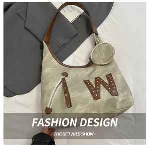 Detailed shot of olive green tote bag featuring rivet W logo and leather shoulder strap