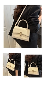 Close-up of off-white woven texture shoulder bag with golden horseshoe buckle details