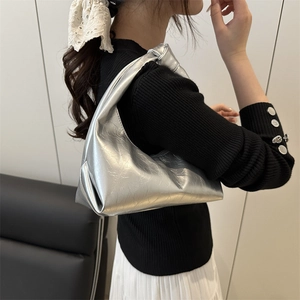 Silver metallic baguette bag with knotted handle and cracked texture in a half-moon shape