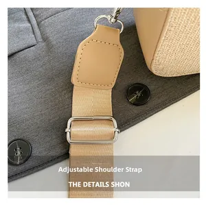 Detail of adjustable nylon camera bag shoulder strap with silver metal buckle and leather