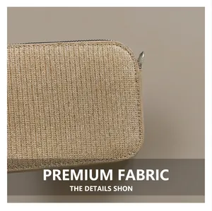 Close-up of golden brown woven fabric with subtle metallic shimmer and silver zipper detail