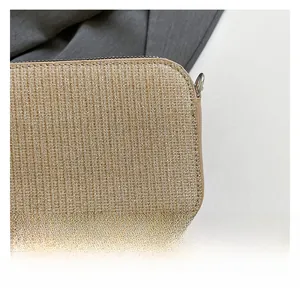 Close-up of golden brown woven fabric with subtle metallic shimmer and silver zipper detail