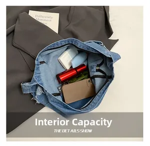 Detail showing the internal capacity of the denim tote bag with frayed edges and pockets