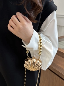 Chic gold shell-shaped crossbody bag with pearl chain handle and metallic finish