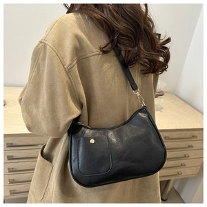 Side view of a vintage black PU leather shoulder bag with gold metal buckle detail
