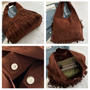 Detail of brown suede tassel bag with magnetic closure and spacious interior storage