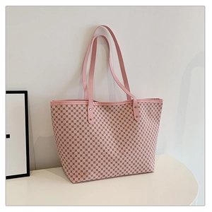 Detail of pink tote bag with geometric dot patterns and durable leather handles
