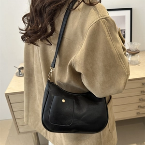 Vintage black half-moon underarm bag with gold magnetic buckle and adjustable strap