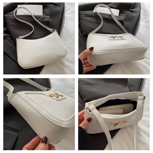 Detail of white PU shoulder bag with gold bow buckle showing interior storage space