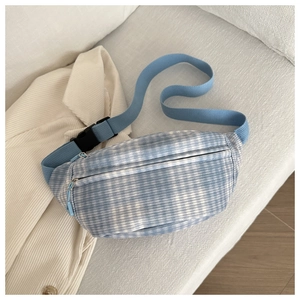 Detail of blue and white checkered corduroy waist bag with dual zippers and buckle strap