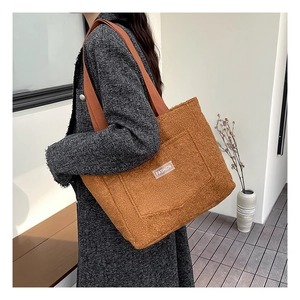 Close-up of caramel faux fur tote bag showing plush texture and FASHION label