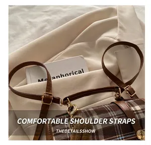 Detail of adjustable leather strap and vintage plaid fabric on a stylish backpack
