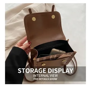 Detail view of the vintage plaid crossbody bag interior with phone and wallet storage