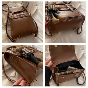 Detail view of brown plaid backpack with vintage PU leather and bear charm decoration