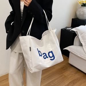 Minimalist white canvas tote bag with large capacity and blue bag lettering for women