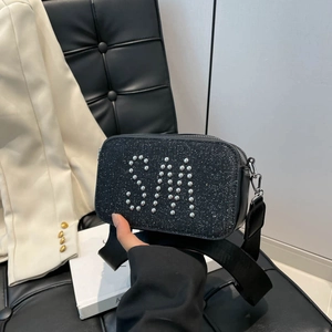 Fashionable black camera bag with silver stud SM logo and wide shoulder strap
