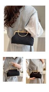 Detail of vintage black seashell bag with gold clasp and textured velvet finish