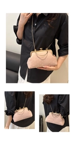 Detail of pink textured fabric handbag featuring gold metal frame and ball clasp closure