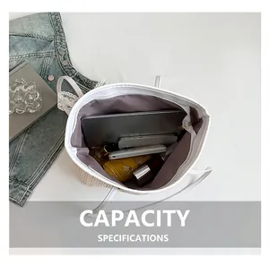 Top view of spacious straw tote bag showing large capacity for laptop and daily items