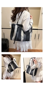 Detailed view of large vertical stripe tote bag with premium leather shoulder straps